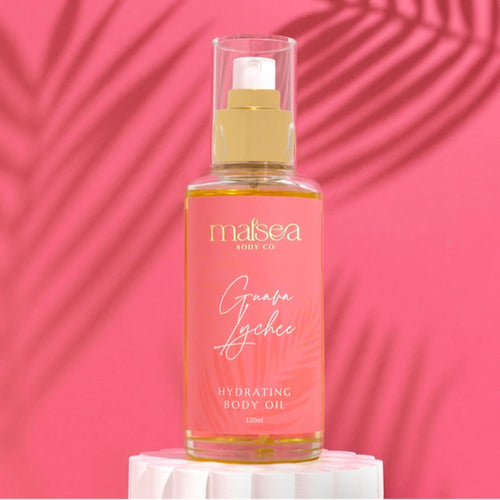 Bottle of Malsea Guava Lychee hydrating body oil on a pink background.  Available at Stylecom.nz 