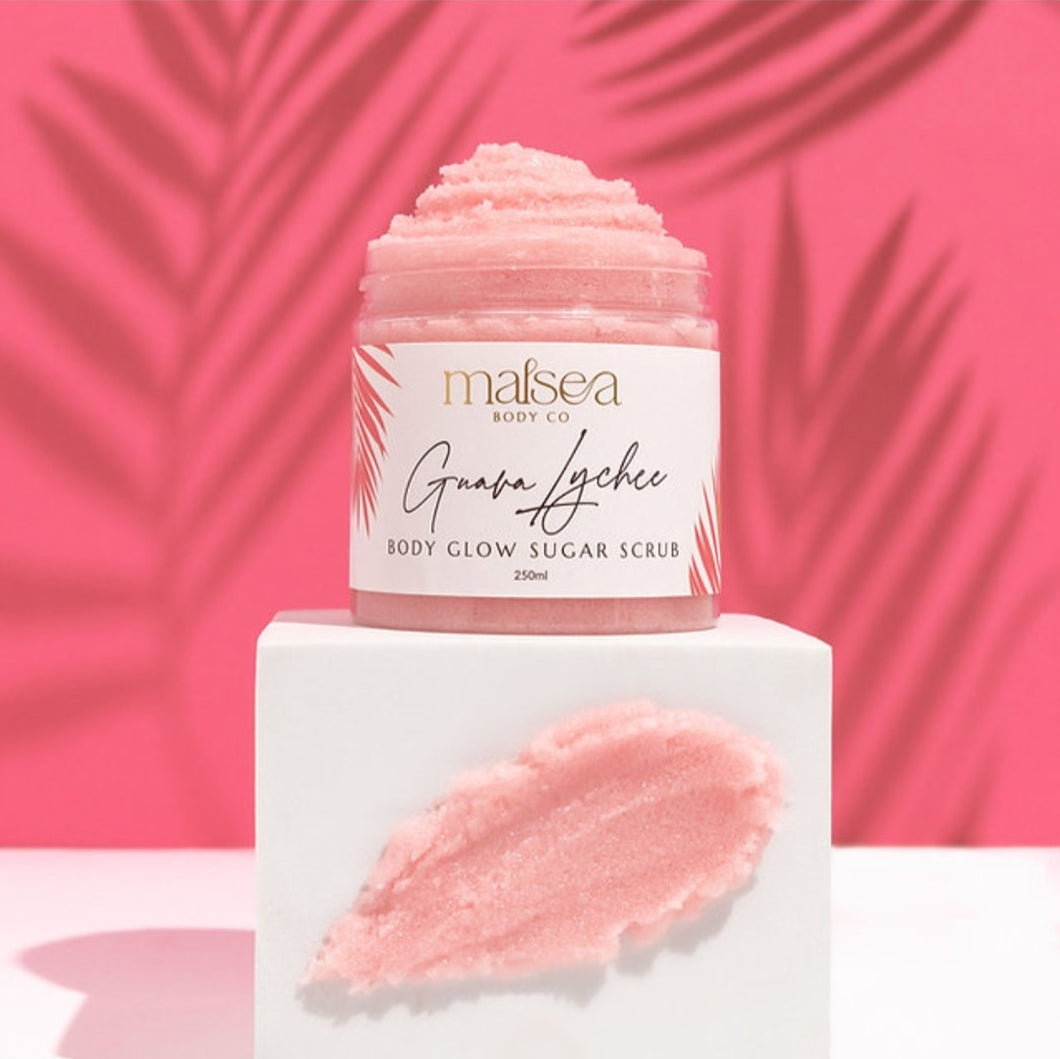 Jar of Guava Lychee body glow sugar scrub with a pink background. Available at Stylecom.nz 